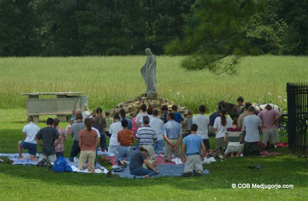 community praying in the field of apparitions