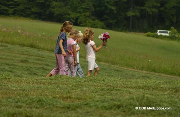 kids carying flowers 