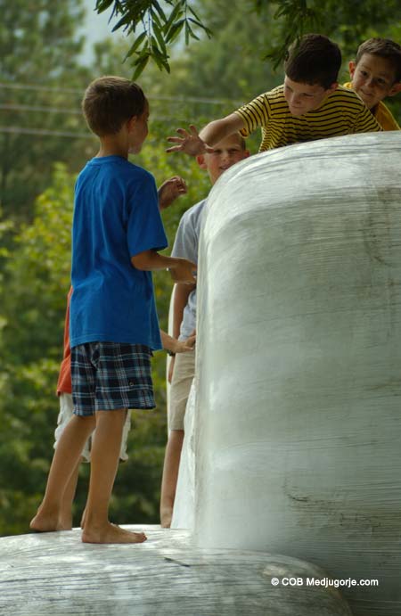 kids playing on silage bales
