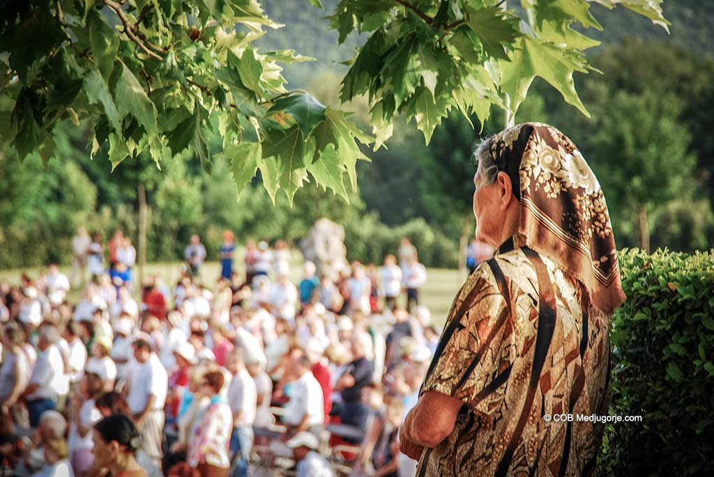 A villager watches Mass in Medjugorje