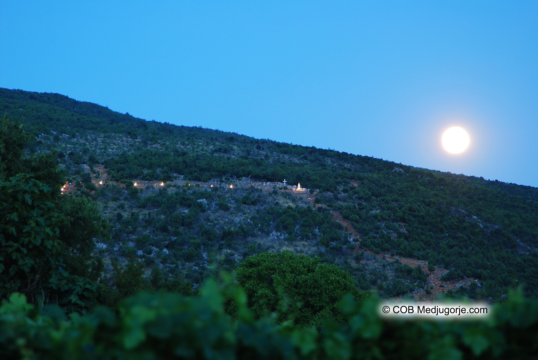 The moon shines over Apparition Mountain in Medjugorje