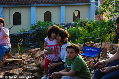 A mother and her children await Our Lady's apparition in medjugorje