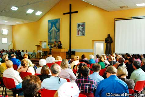 pilgrims in Medjugorje listen to visionary Jakov