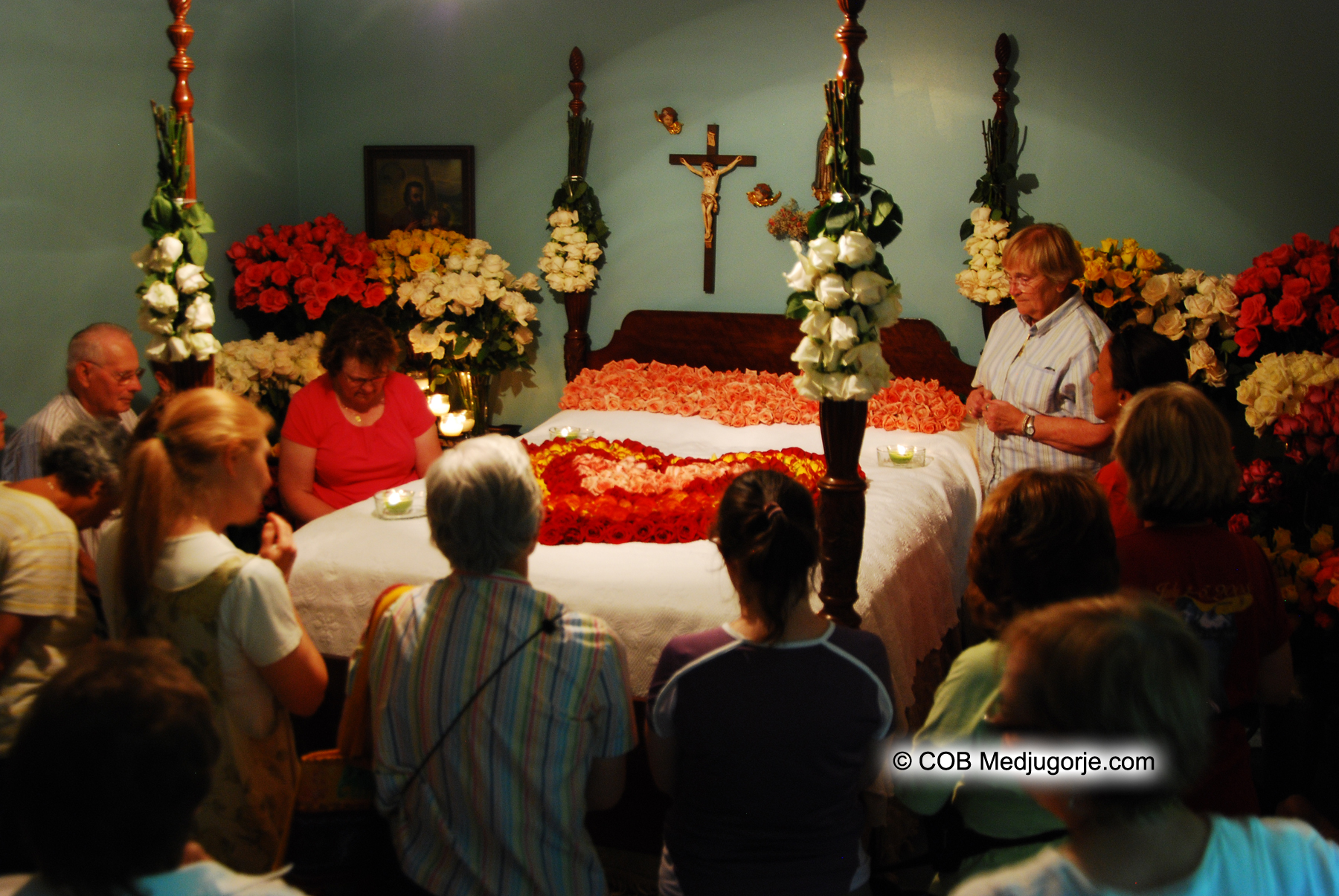 pilgrims praying in the bedroom of apparitions