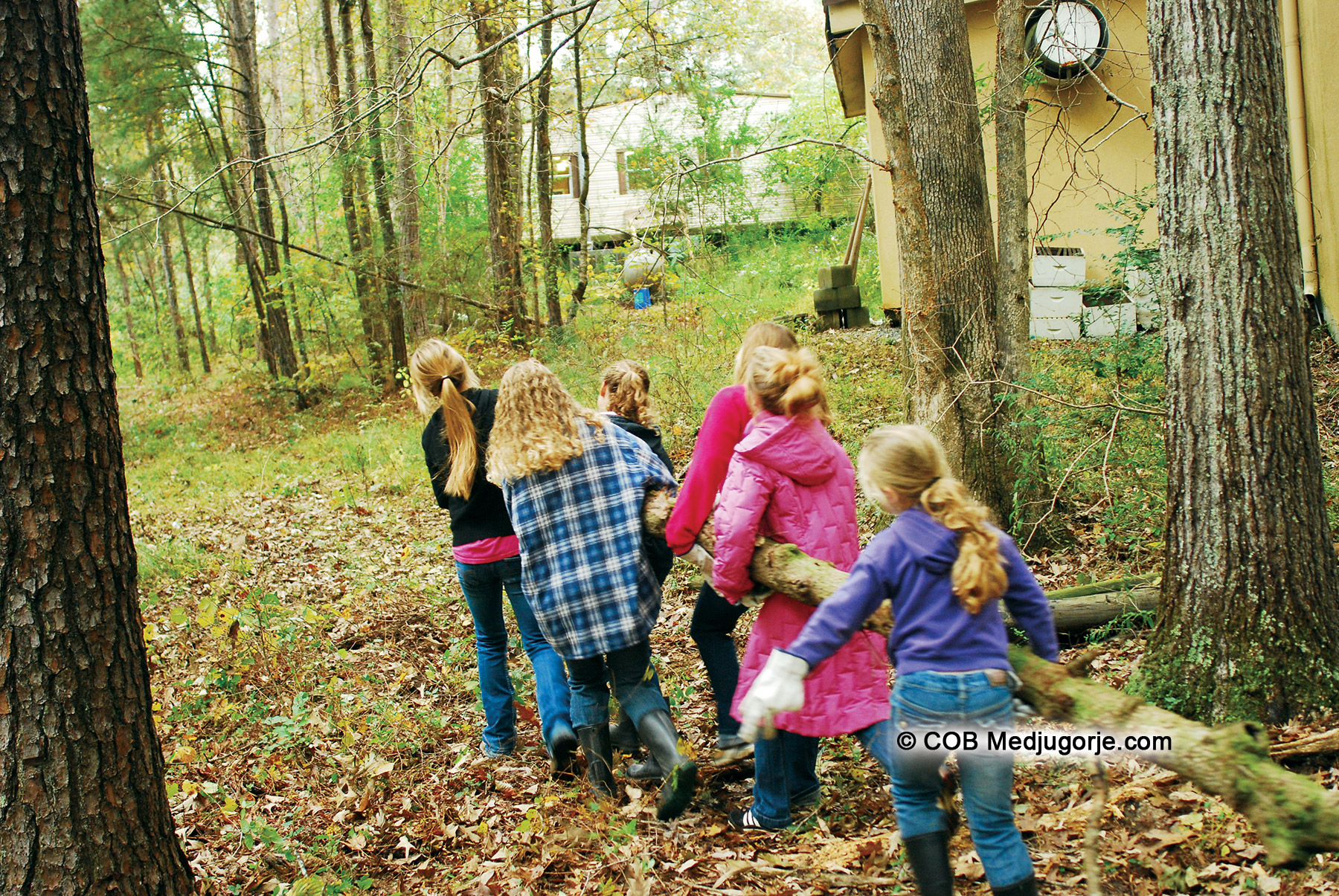 community children carrying log