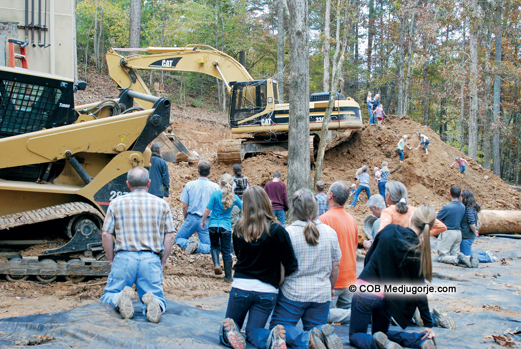 community praying at retooling construction site