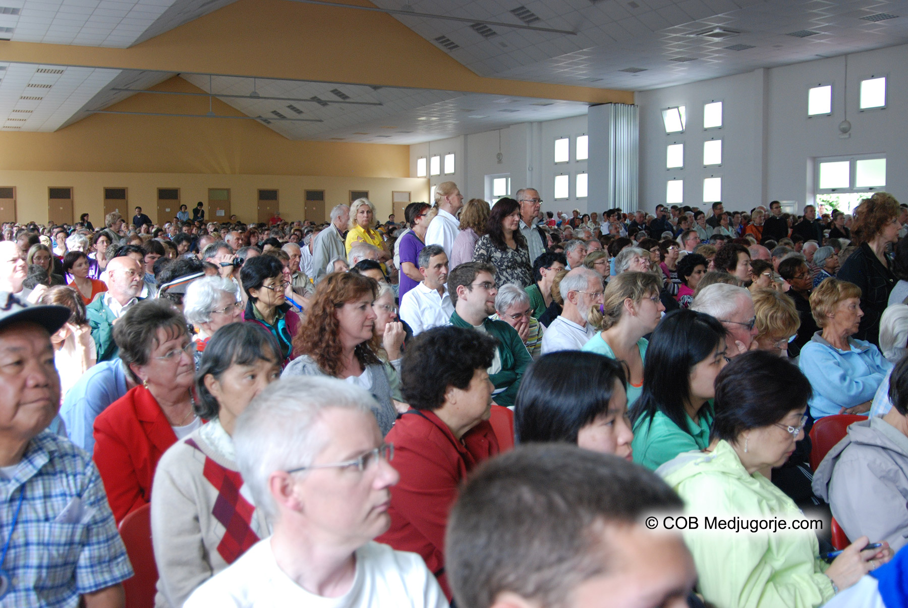 crowd of pilgrims listen to medjugorje visionary marija testimony