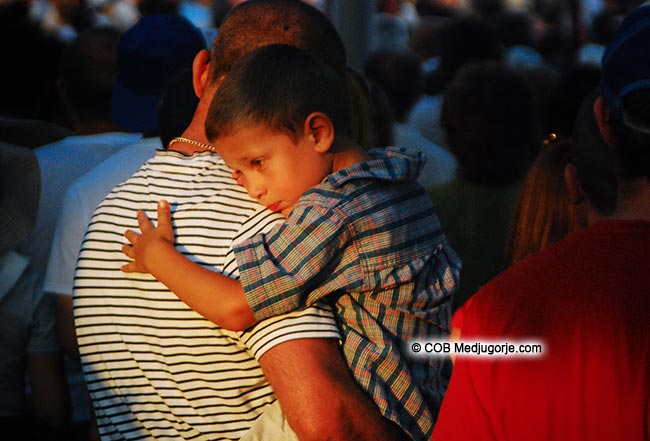 A pilgrim and his son in Medjugorje