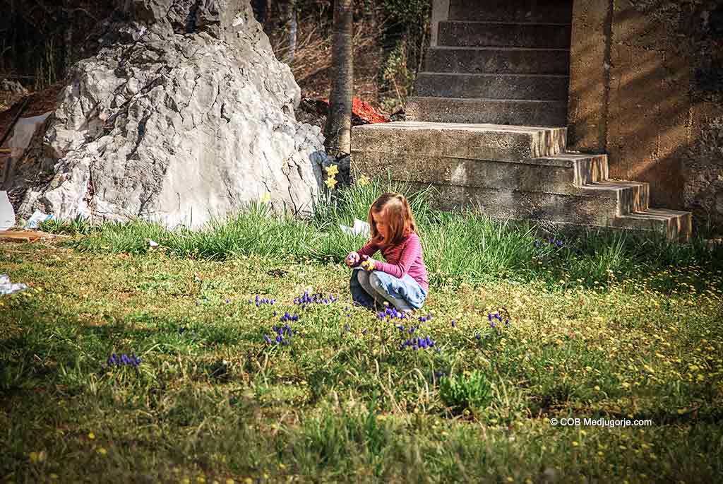 A young child with flowers in Medjugorje