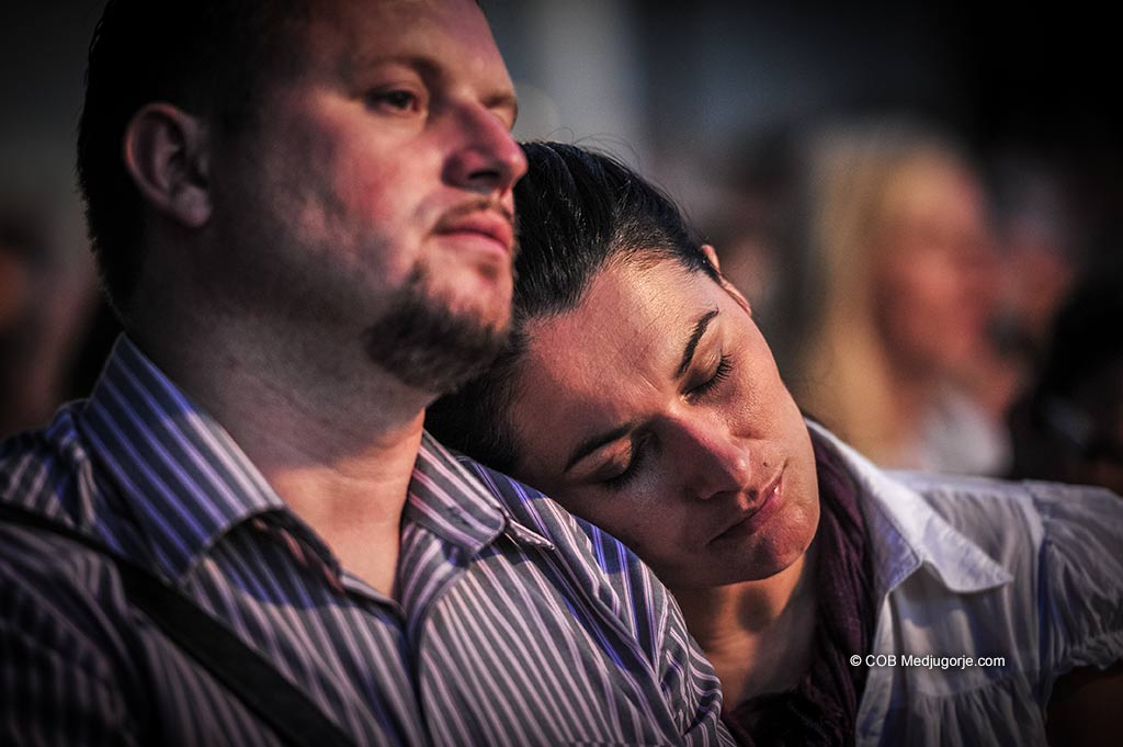 A couple prays together at St. James Church in Medjugorje
