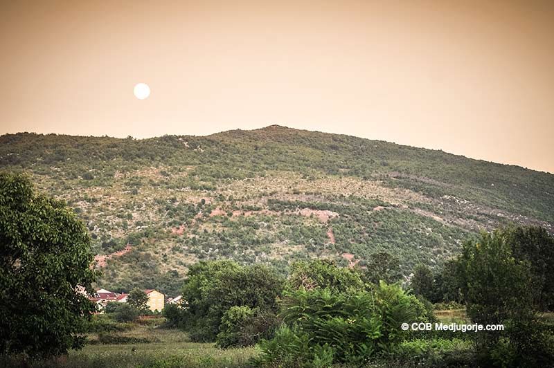 The moon rises over Apparition Mountain in Medjugorje.