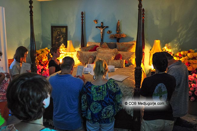 Pilgrims praying in the Bedroom of Apparitions