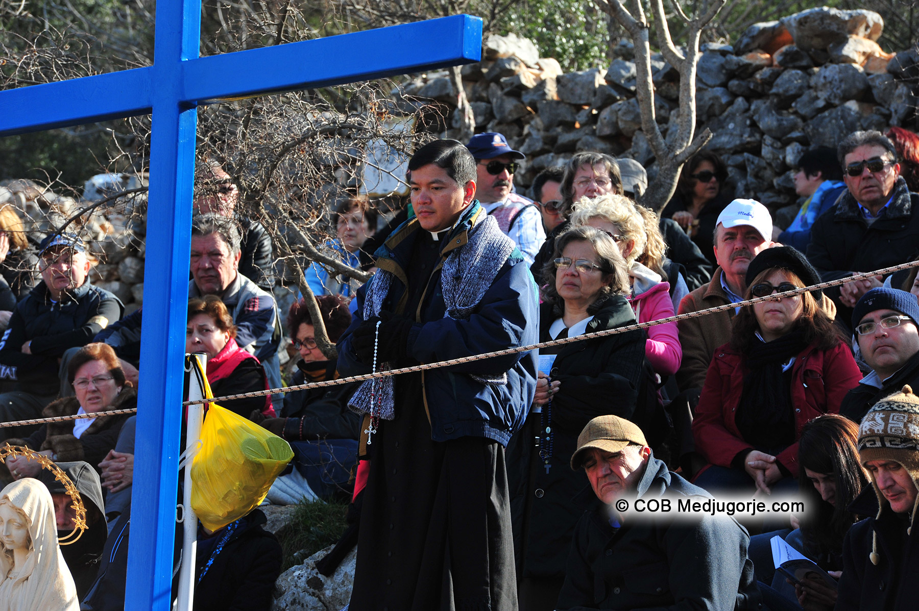 March 18, 2012 Pilgrims praying with Priest