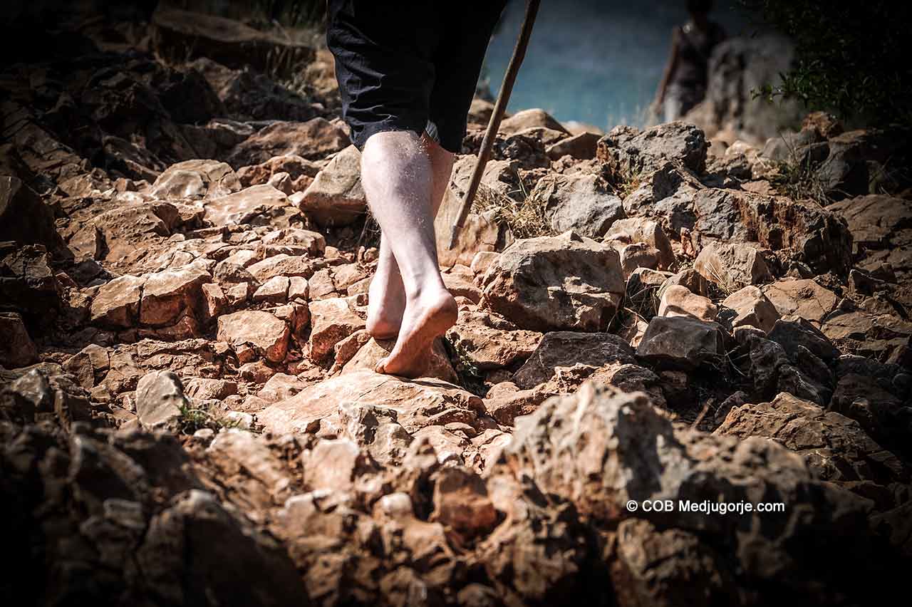 Pilgrim walking barefoot in Medjugorje