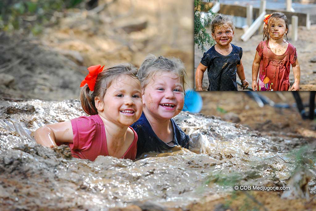 Caritas Community Kids playing in Mud