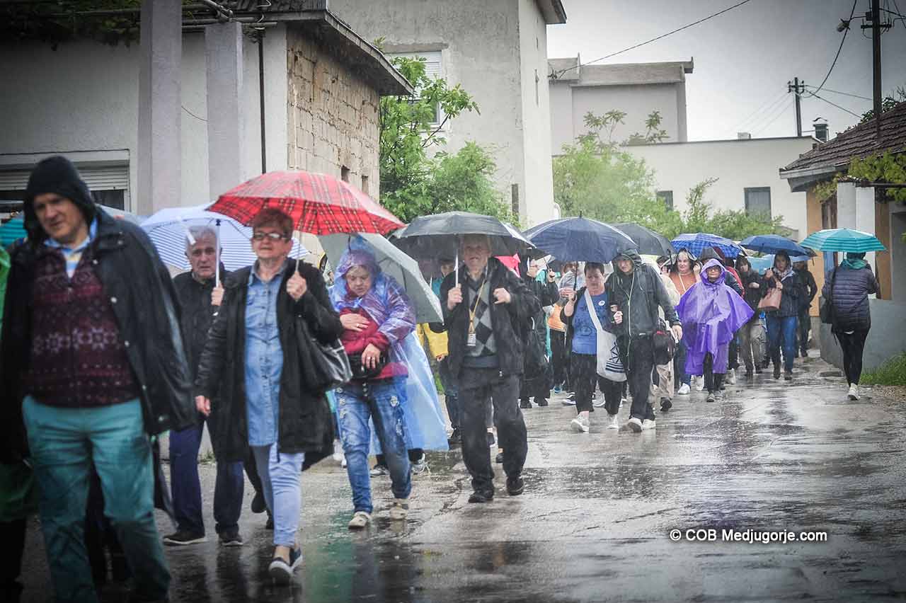 Pilgrims walking in the rain in Medjugorje April 29, 2019