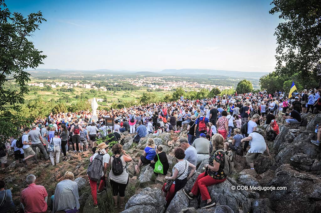 A crowd of thousands of pilgrims pray on Apparition Mountain, June 25, 2019