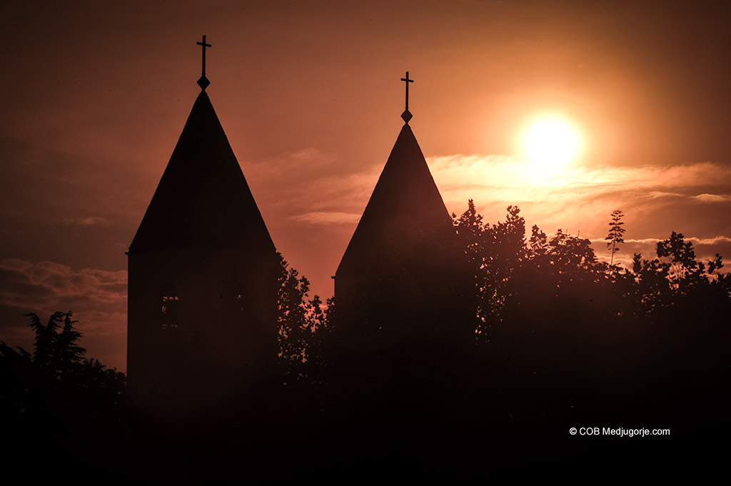 The setting sun behind St James Church in Medjugorje