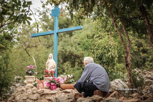 Pilgrim at the Blue Cross in Medjugorje