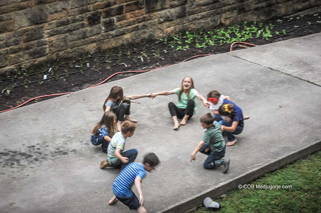 Caritas Kids playing ring around the rosie